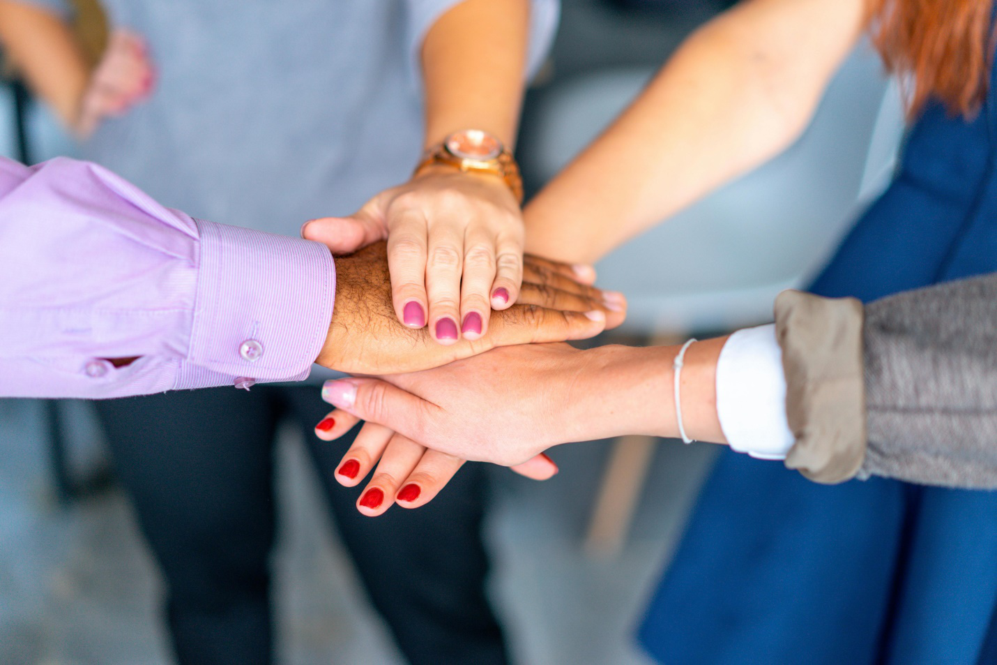group of hands on top of one another